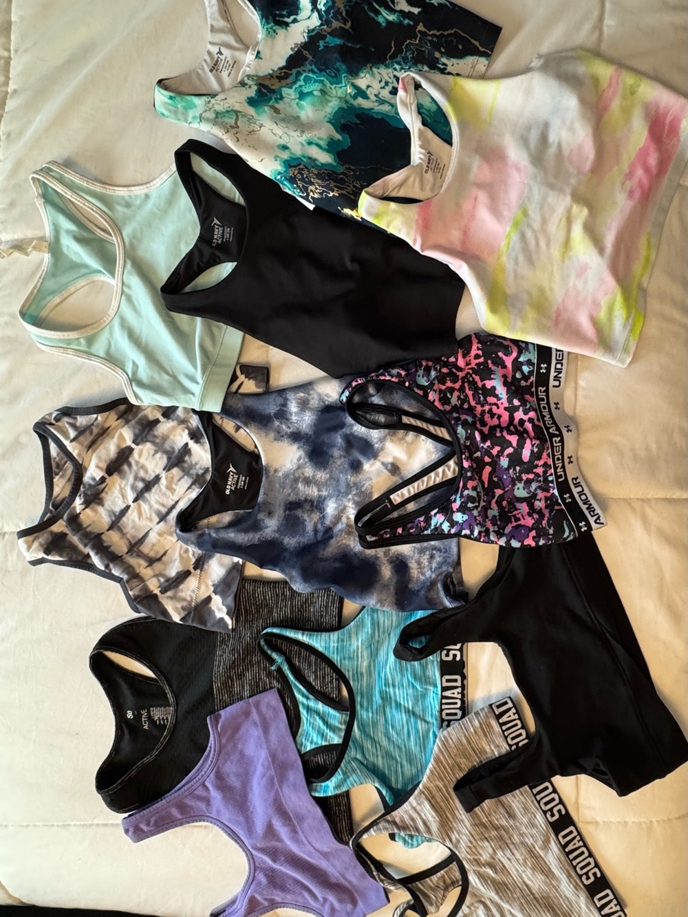 Variety of girls sports tops and tanks.